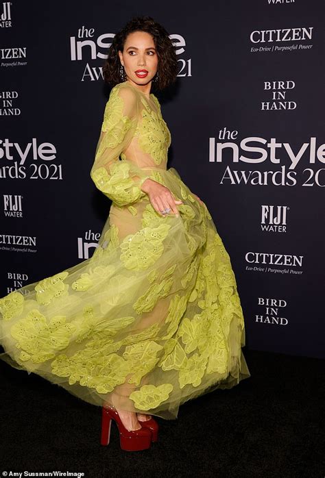 Jurnee Smollett goes nearly NUDE beneath sheer neon gown at。